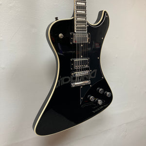 A Hagstrom Fantomen Custom Black electric guitar, featuring white trim, chrome hardware, Lundgren Design humbuckers, and four control knobs, hangs on a white wall.