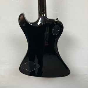 The back of a Hagstrom Fantomen Custom Black electric guitar with two access panels, photographed against a plain white wall.