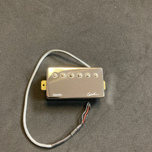 A Godin Neck Humbucker pickup with NICKEL cover GAHN1, crafted by Godin for the A6, includes six adjustment screws and an attached wire, offering superior sound enhancement while displayed on a black surface.