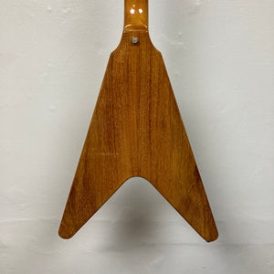 Back view of a 1975 Gibson Flying V electric guitar body with a distinctive V-shaped design, reminiscent of vintage models, showcased against a plain white background.