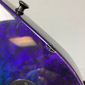 Close-up of a 1995 Jackson SL1 Soloist Custom Shop electric guitar body in the distinctive Eerie Dess Swirl finish, showcasing a prominent screw and visible scratches—details that highlight this USA-made instrument’s authentic character. Includes case.