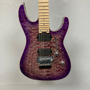 The 2019 ESP USA M-II Purple Haze Burst w/Case, crafted in the USA by ESP, features a stunning quilted maple top in Purple Haze Burst, two black humbucker pickups, a maple fretboard, and a Floyd Rose tremolo bridge—photographed here against a plain light gray wall.