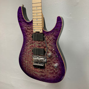 A striking 2019 ESP USA M-II Purple Haze Burst electric guitar by ESP, this American-made instrument boasts a quilted maple top, maple neck, dual humbucker pickups, Floyd Rose tremolo, and chrome hardware—beautifully displayed on a light gray wall.