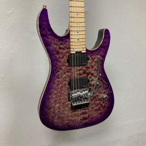 The ESP 2019 USA M-II Purple Haze Burst electric guitar features a breathtaking quilted maple top finished in Purple Haze Burst, a maple neck, dual humbucker pickups, and a Floyd Rose tremolo system. This American-made ESP model is shown photographed against a plain light-colored wall and comes complete with its case.