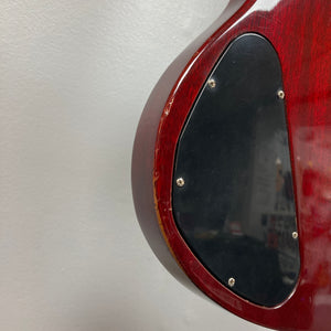 Close-up of the back of a Gibson 1977 SG Standard Cherry electric guitar, featuring a mahogany body and a black plastic electronics cover plate secured with screws—a classic detail from the Kalamazoo era.