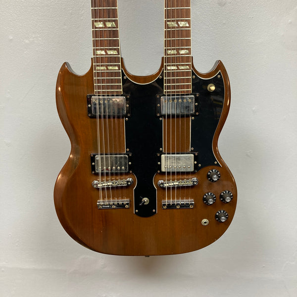 A 1978 Gibson EDS-1275 Double Neck Walnut electric guitar by Gibson, featuring a brown walnut finish, black pickguards, and multiple control knobs, photographed against a plain white background.