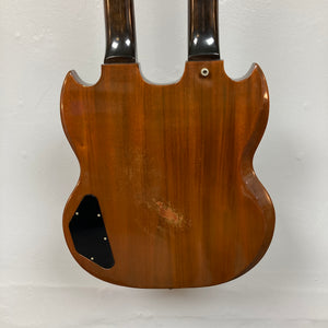 Rear view of a 1978 Gibson EDS-1275 Double Neck Walnut by Gibson, featuring a wooden walnut finish, visible signs of wear, and a black cover plate on the lower left side.