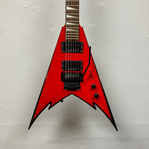 A Jackson Phil Demmel Demmelition King V w/Case electric guitar by Jackson, featuring a sharp V-shaped red body, black hardware, Floyd Rose tremolo system, dual humbucker pickups, and three control knobs, photographed against a plain white background.