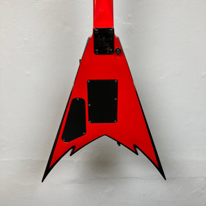 A striking Jackson Phil Demmel Demmelition King V electric guitar body in vivid red with a distinctive V shape, accented by black trim and featuring two rectangular black backplates, photographed against a white background. This standout instrument from Jackson showcases the signature King V design and is ready to be outfitted with a Floyd Rose tremolo for peak performance. Includes case.