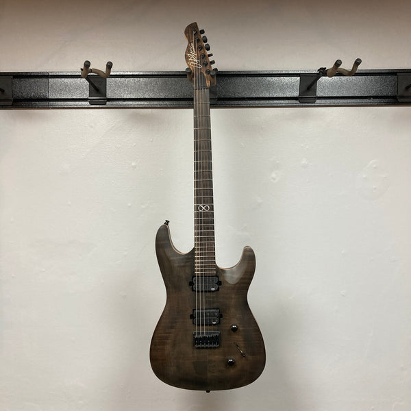 Chapman ML1 Pro Modern Lunar electric guitar by Chapman, featuring a dark wood finish, dual humbucker pickups, 24-fret neck, two control knobs, and a switch, photographed against a plain white wall.