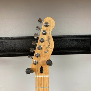 A Fender Player Telecaster 75th Anniversary Butterscotch Used guitar headstock with six tuning pegs, featuring a classic maple fingerboard, mounted on a wall hanger against a white background.