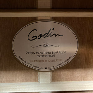 The Godin label inside the body clearly presents the model name “Godin Century Maho Rustic Burst EQ SF,” along with its unique serial number and the phrase “Hand-crafted in Canada” in both English and French. As a dreadnought acoustic electric made from solid wood, this guitar exemplifies Godin’s dedication to quality and expert craftsmanship.