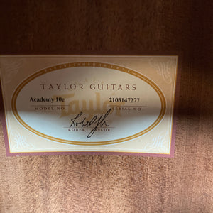 Label inside a Taylor Academy 10e Acoustic-Electric Guitar w/GigBag shows “Academy 10e,” serial number 2103147277, and Robert Taylor’s signature on wood.