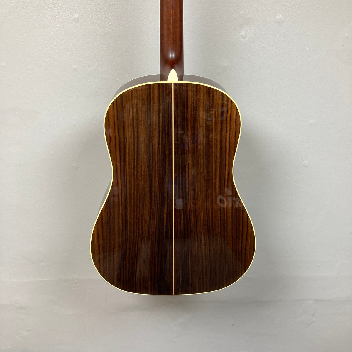 The back of an Alvarez DYMR70SB Yairi Masterworks Acoustic Guitar Sunburst w/Case features a dark wood finish, visible grain, center seam, and light edge binding.