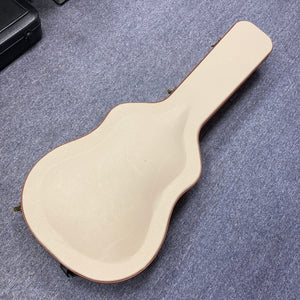 A beige guitar case rests closed on a grey carpet, shaped for an Alvarez DYMR70SB Yairi Masterworks Acoustic Guitar Sunburst w/Case inside.