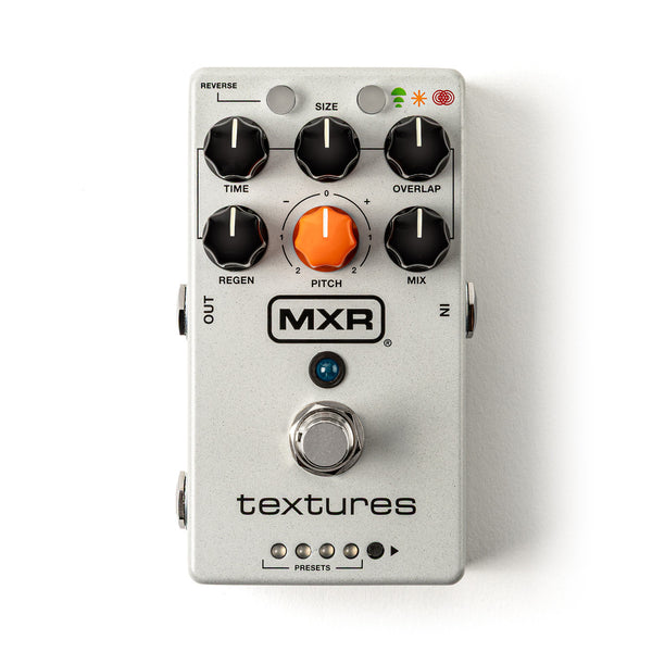 The MXR Textures M310 Pedal by MXR features a sleek silver design with five black knobs, one orange knob, a footswitch, three small indicator lights, and input/output jacks—ideal for creating immersive soundscapes or experimenting with granular synth-inspired effects.