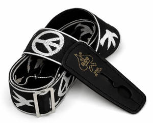 The D'Andrea Ace Pro Lock-It 2" Jacquard Guitar Strap features black jacquard with white peace and dove designs, a metal buckle, and "ace Made in USA" embossed in gold on the leather end—vintage Ace style reissued.