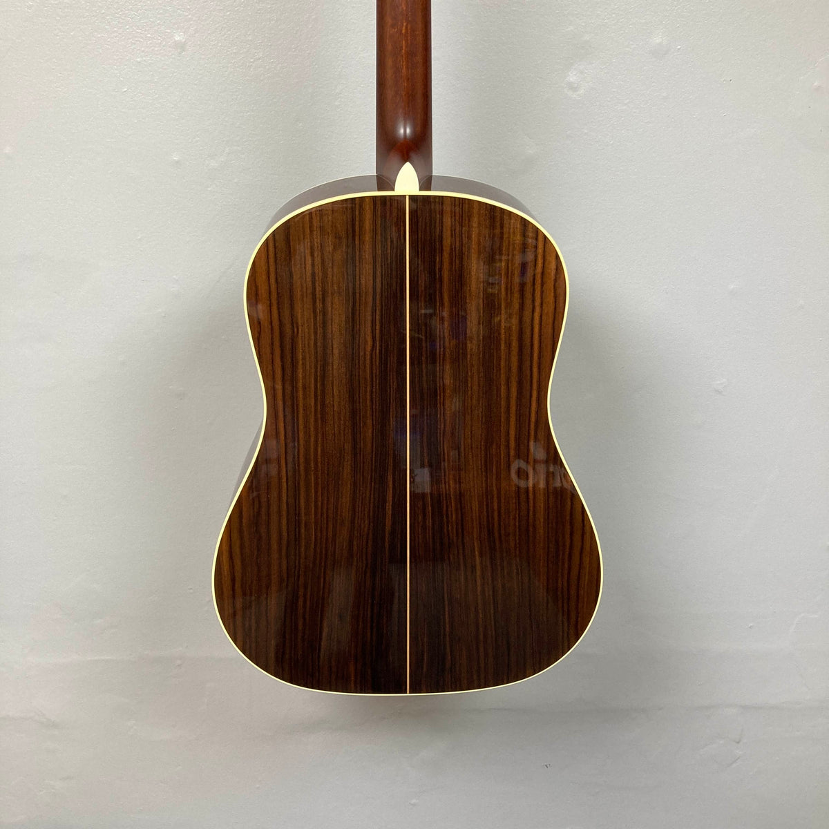 Back view of an Alvarez DYMR70SB Yairi Masterworks Acoustic Guitar Sunburst w/Case Used slope-shoulder dreadnought, showing a dark wood back and a light-colored heel cap.