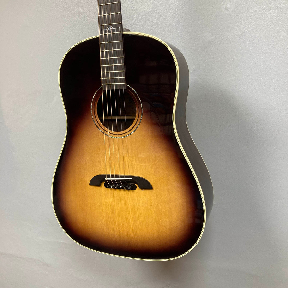 Alvarez DYMR70SB Yairi Masterworks Acoustic Guitar Sunburst w/Case Used slope-shoulder dreadnought acoustic guitar with a sunburst finish, hanging against a plain gray wall.