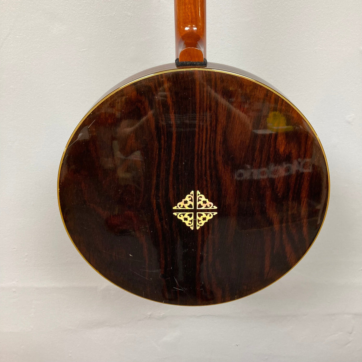 Close-up of the Alvarez Minstrel 4-string Tenor Banjo, 1970s, highlighting intricate fretboard inlays and wood grain resonator.