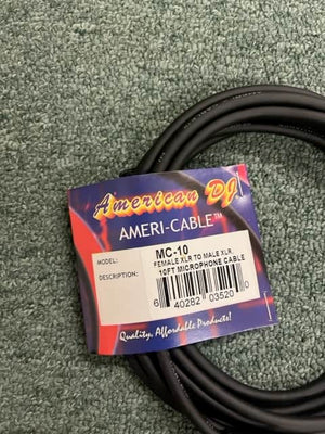 A coiled black American DJ MC-10 10ft XLR Microphone Cable lies on a textured green surface, with a label indicating "Female XLR to Male XLR.