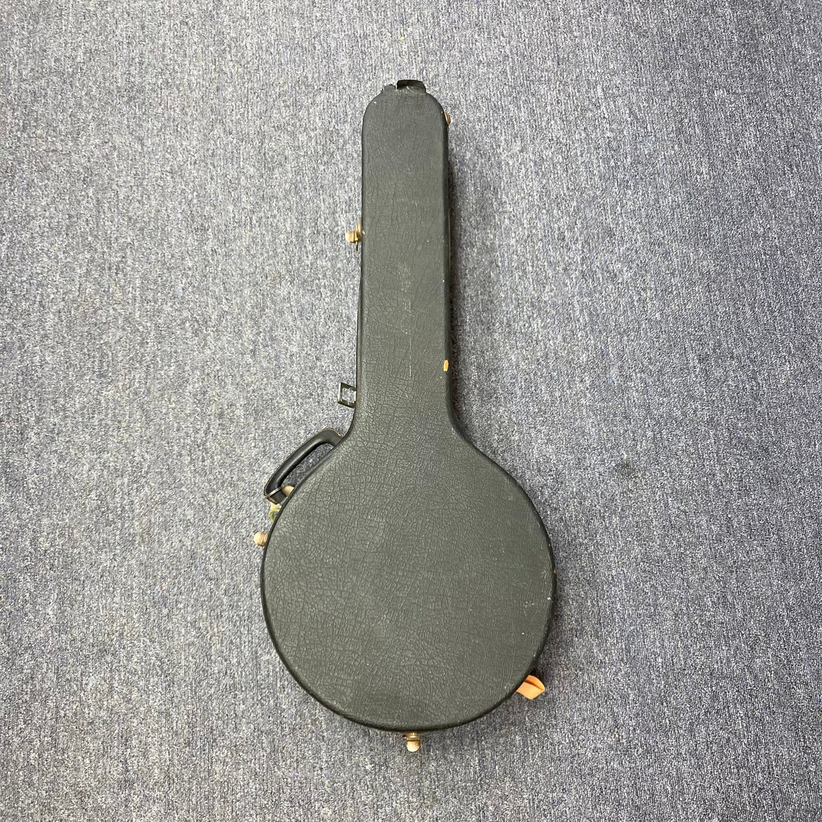 Aria Tenor Banjo 4 String 1970s in black case on carpet, showcasing vintage craftsmanship and quality hardware.