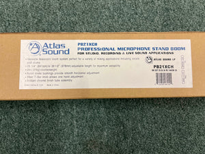 Brown box with Atlas Sound branding, labeled "Atlas Sound PB21XCH Professional Microphone Stand Boom" for studio and live sound use, shown on a green carpet.