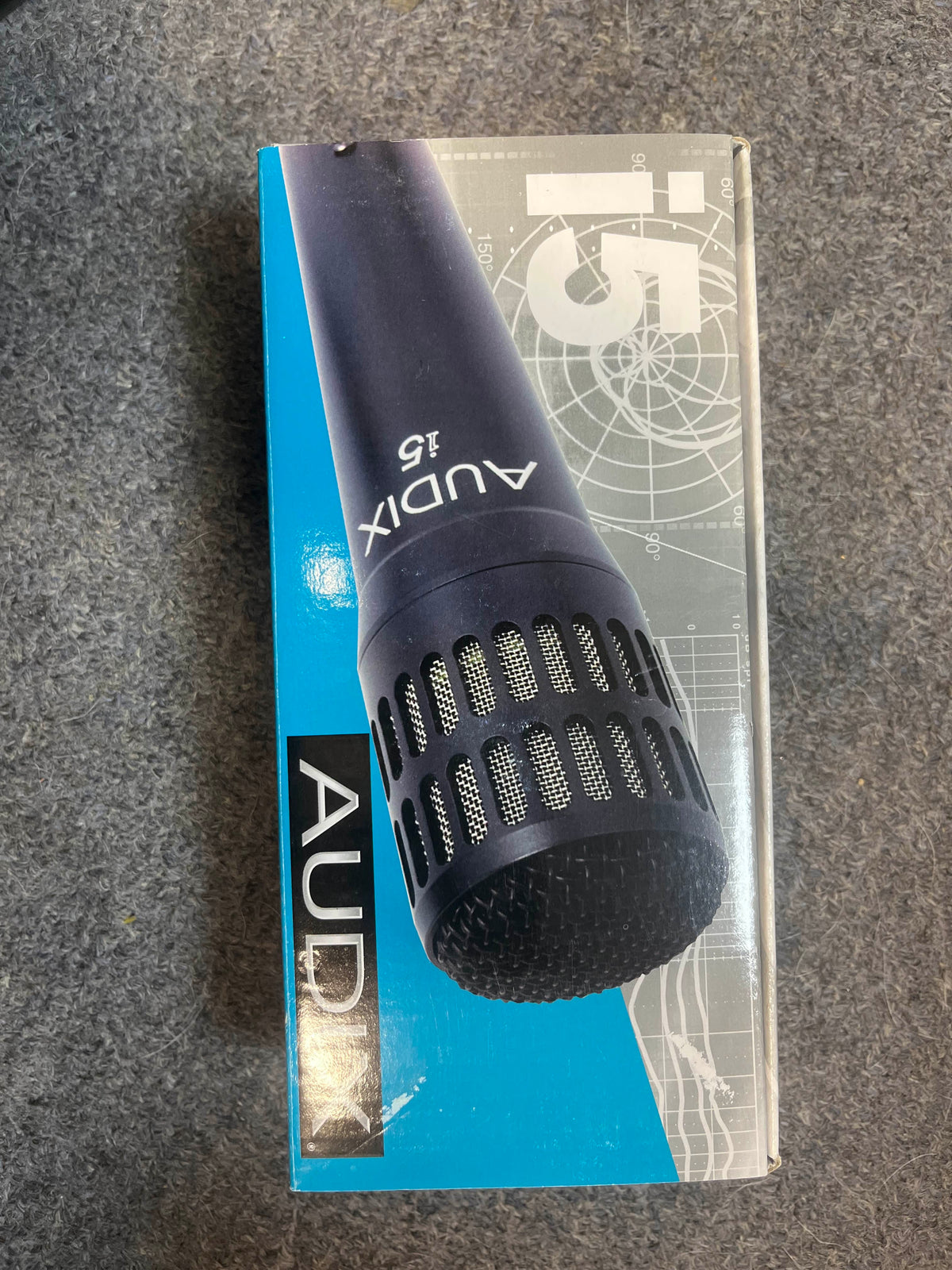A box with the Audix i5 All-Purpose Dynamic Instrument Microphone (Preowned) by Audix is displayed on a grey surface.