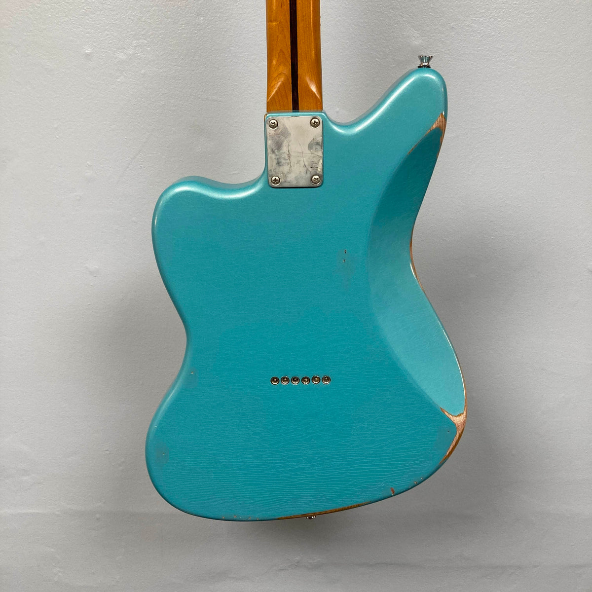 Back view of a Big River Jazzcaster Custom Relic Pelham Blue Used electric guitar with an offset body and distressed wear along the edges.
