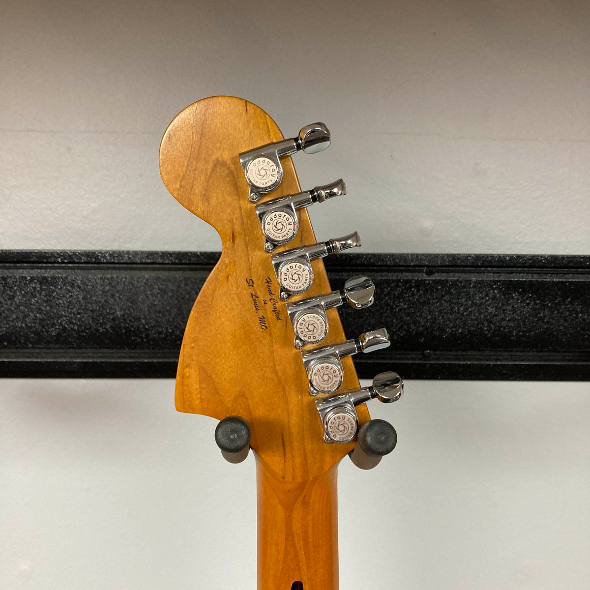 Back of a Big River Jazzcaster Custom Relic Pelham Blue Used headstock showing chrome tuning machines and “Hand Crafted in St. Louis, MO” printed on the wood.