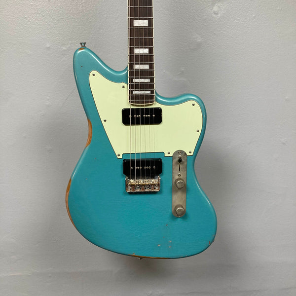 Big River Jazzcaster Custom Relic Pelham Blue electric guitar featuring an offset body, white pickguard, and two black soapbar Lollar pickups.