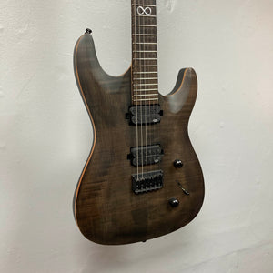 The Chapman ML1 Pro Modern Lunar electric guitar by Chapman, featuring a dark wood finish, dual humbucker pickups, two control knobs, a fixed bridge, and a sleek 24-fret neck, is displayed hanging against a plain white wall.