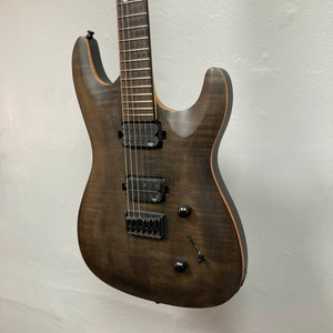 Chapman ML1 Pro Modern Lunar electric guitar by Chapman, featuring a dark wood finish, dual humbucker pickups, two control knobs, and a selector switch, hangs against a plain light-colored wall. This modern guitar also offers a sleek 24-fret fingerboard for extended playability, and comes with a case.