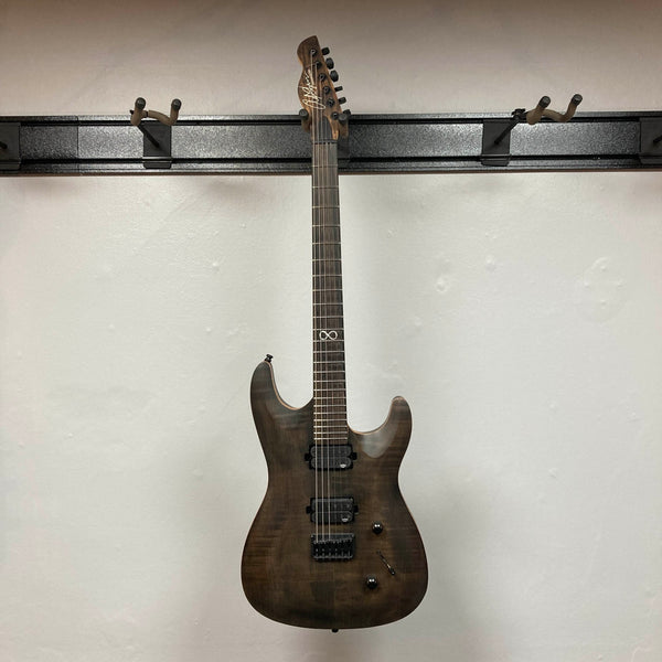 Chapman ML1 Pro Modern Lunar electric guitar by Chapman, featuring a dark wood finish, dual humbucker pickups, 24-fret neck, two control knobs, and a switch, photographed against a plain white wall.