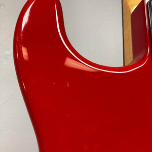 Close-up of the Charvel Model 4 HSS Red w/OHSC Consign electric guitar by Charvel, showing its glossy finish and contoured upper body against a plain background.