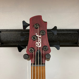 Close-up of the Cort B5 Artisan Element Open Pore Burgundy Red Bass Guitar, showcasing strings, fretboard, and pickups.