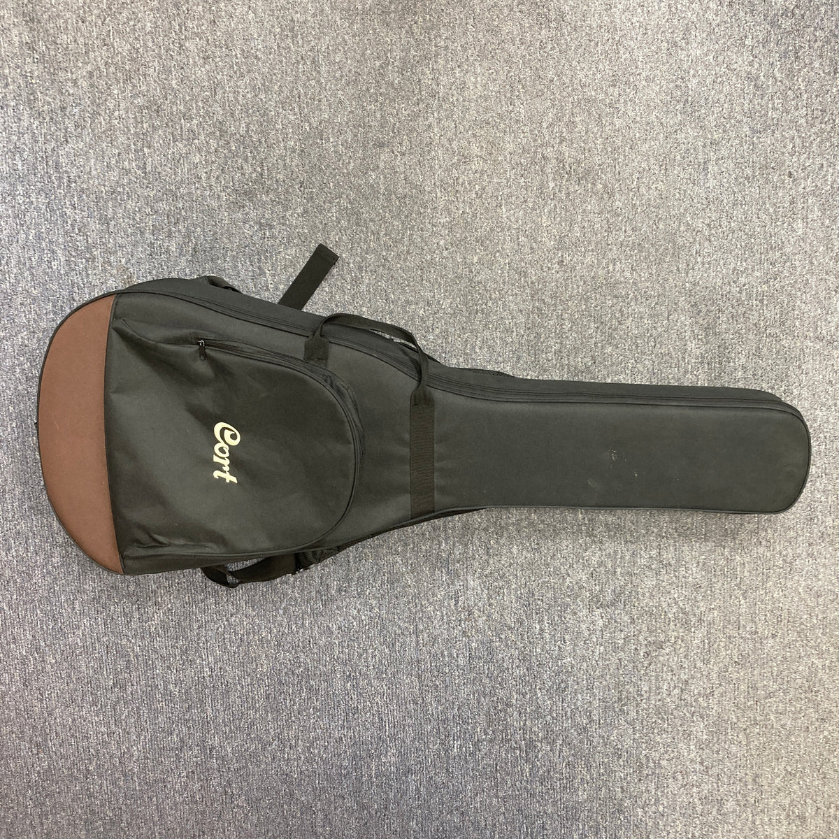 Cort Core-OC Blackwood Acoustic Guitar with solid blackwood body and mahogany neck, showcased on carpet, highlighting premium craftsmanship and sound quality.