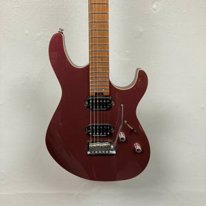 A Cort FW-G300 PRO electric guitar in Vivid Burgundy, featuring two humbucker pickups, three control knobs, and a tremolo bridge, hangs against a white wall.