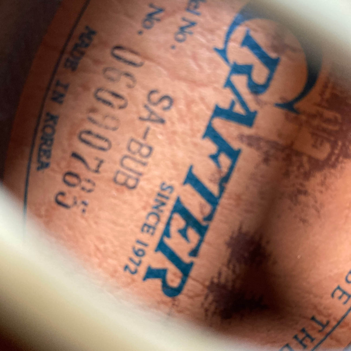 Close-up of a stamped label inside a used Crafter SA-BUB Acoustic Electric Guitar, showing "CRAFTER SINCE 1972," model "SA-BUB," serial "UC090785," and "MADE IN KOREA" in blue—perfect for onstage performance.