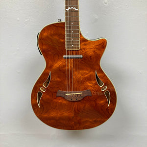 A close-up of the Crafter SA-BUB Acoustic Electric Guitar Used Consign by Crafter, featuring a glossy wood finish, decorative sound holes, and cutaway body for great plugged-in performance, shown against a plain white background.