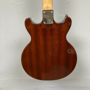 Back view of the Dean Boca Trans Amber Burst 12 String by Dean, featuring a glossy, semi-hollow brown body with visible wood grain, metal neck plate, and slight surface scratches; includes gigbag.