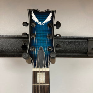 Dean Thoroughbred John Connolly Trans Blueburst guitar on a stand, showcasing its solid mahogany body and flame maple top, ideal for versatile musical styles.