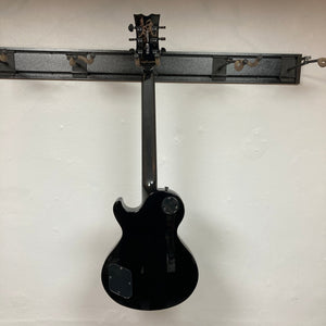 Dean Thoroughbred John Connolly Trans Blueburst electric guitar hanging on a wall, showcasing its premium build and versatile design.