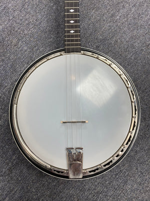 Deering Deluxe 4-String Banjo on carpet, showcasing the neck and metal hardware details.