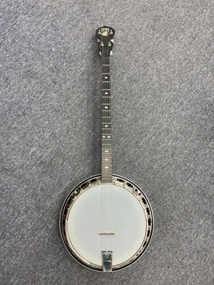 Deering Deluxe 4-String Banjo placed on a carpet, showcasing its intuitive design for guitarists and banjo enthusiasts.