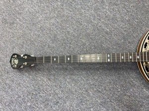 Deering Deluxe 4-String Banjo on the floor, showcasing its guitar-like tuning for easy transition between instruments.