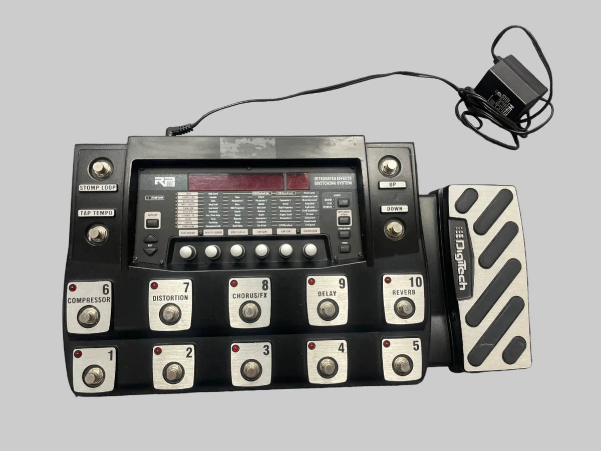 Used Digitech RP1000 Multi-Effects Floor Processor with amp modeling, 12 footswitches, expression pedal, display, and power adapter on a plain gray background.
