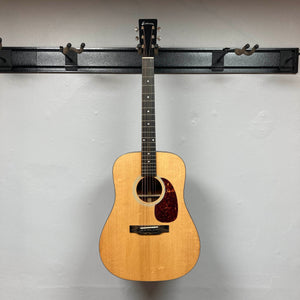 Eastman E1D Dreadnought Natural w/Gigbag Used acoustic guitar with a solid Sitka spruce top and dark pickguard, hanging on a wall rack.