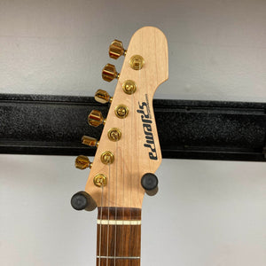 Headstock of an Edwards ESP E-SN-185-TO Takayoshi Ohmura Twinkle Pink electric guitar, featuring gold tuning pegs, mounted on a wall hanger against a plain background.