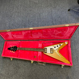 Epiphone 1958 Korina Flying V guitar in a hardshell case, showcasing a Korina body and neck, with gold hardware and premium electronics.